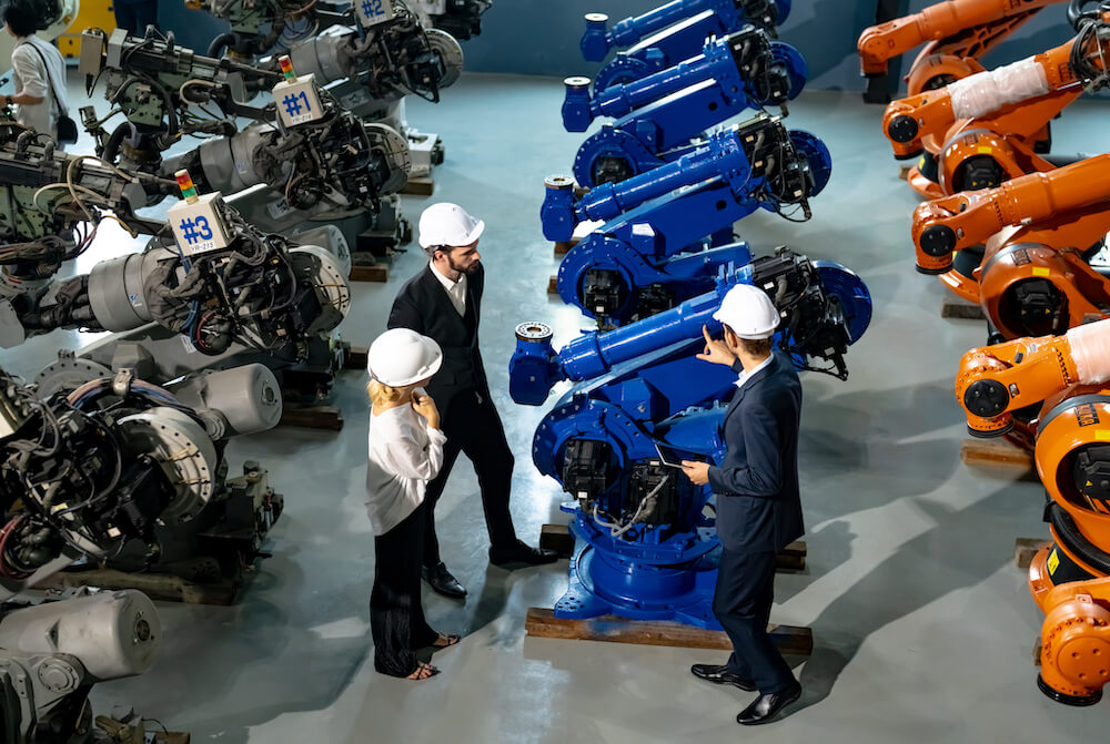 Three people looking at machinery